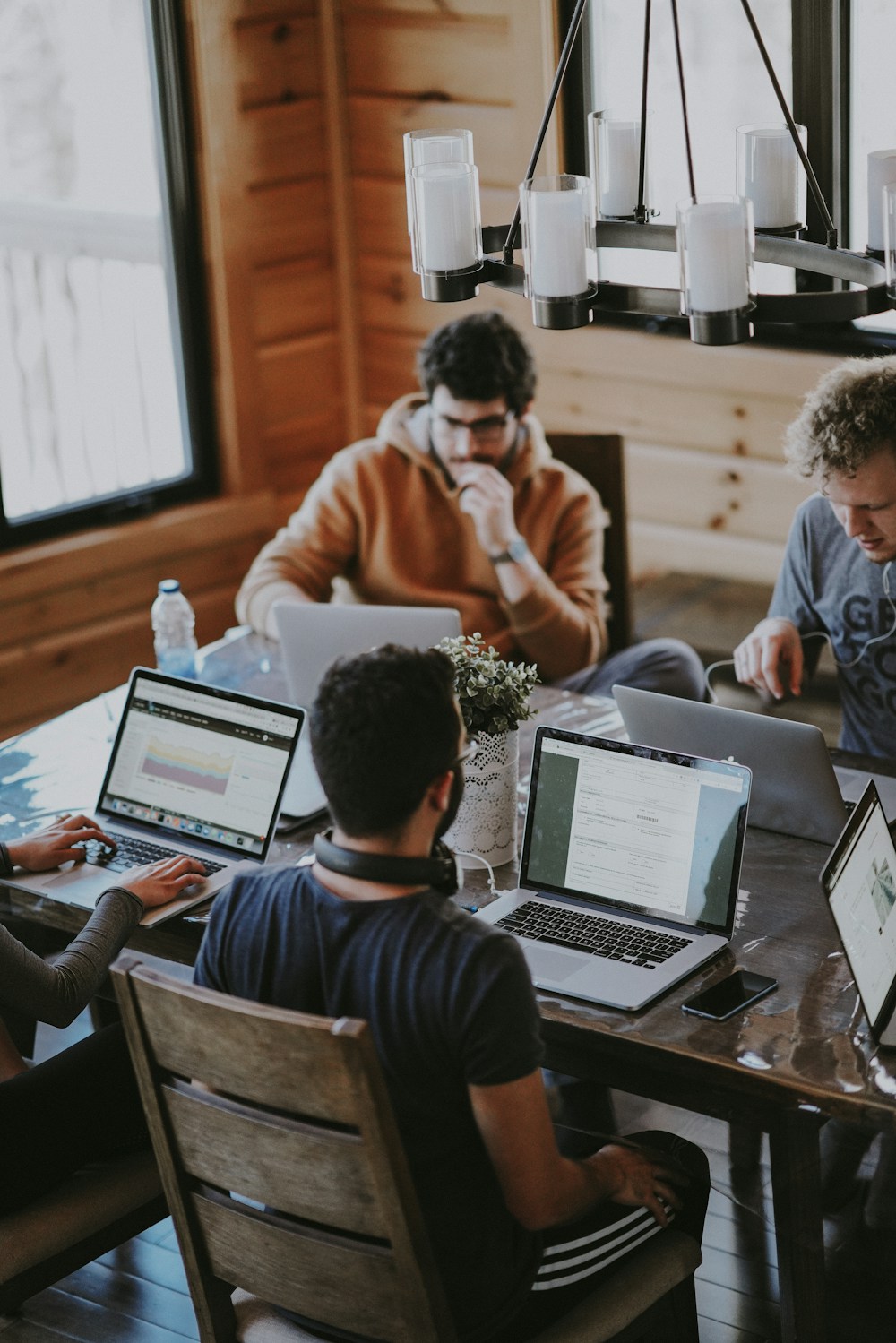 Colleagues working together around a table in a warm, naturally lit office